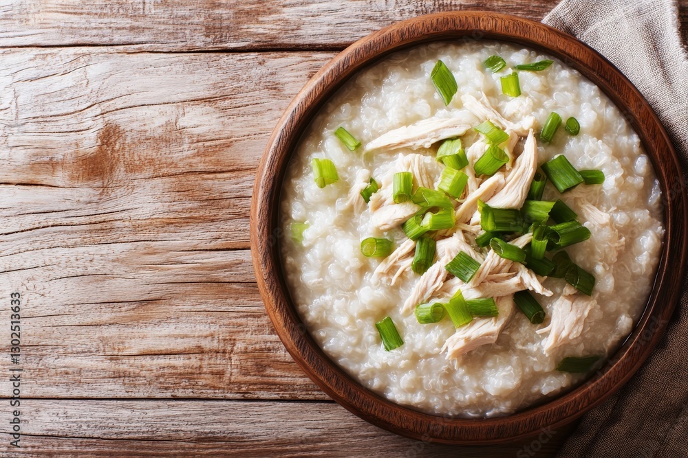 Creamy Chicken Congee with Fresh Green Onions in a Rustic Wooden Bowl Creamy Chicken Congee with Fresh Green Onions in a Rustic Wooden Bowl