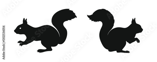 Black Silhouettes of Two Squirrels in a Crouching Position