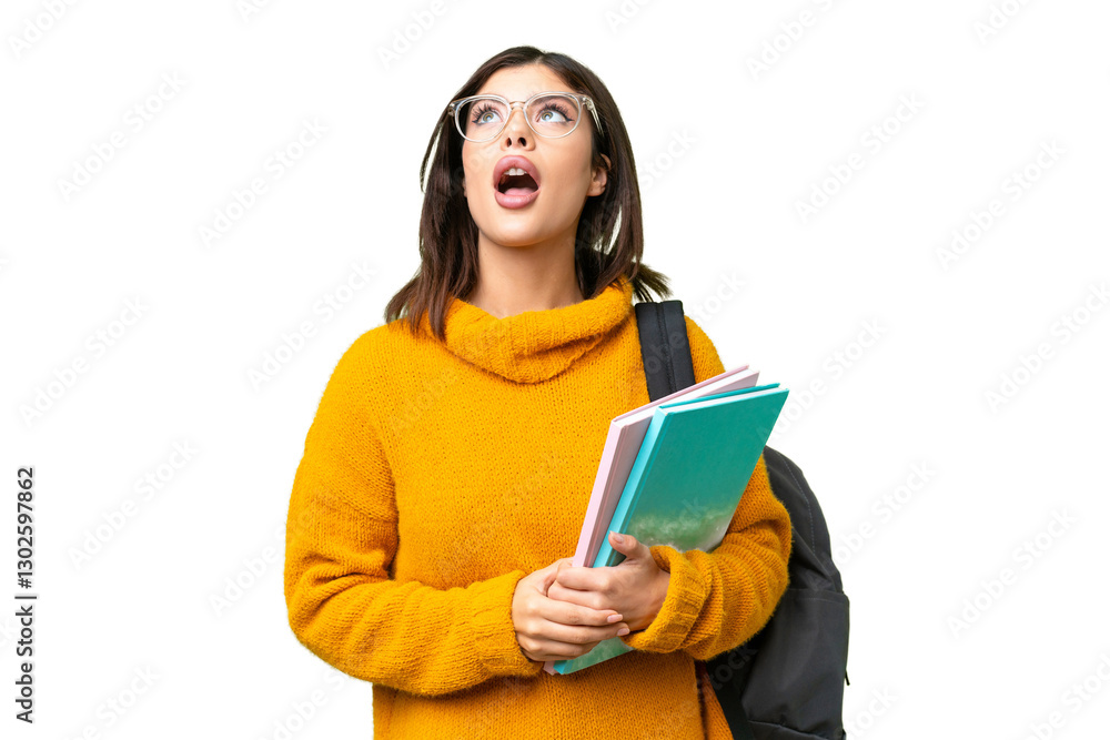 Young student woman over isolated chroma key background looking up and with surprised expression Young student woman over isolated chroma key background looking up and with surprised expression