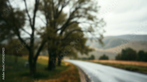 Wallpaper Mural A soft, blurred background of a winding road lined with trees, creating a tranquil and atmospheric scene perfect for nature-inspired projects. Torontodigital.ca