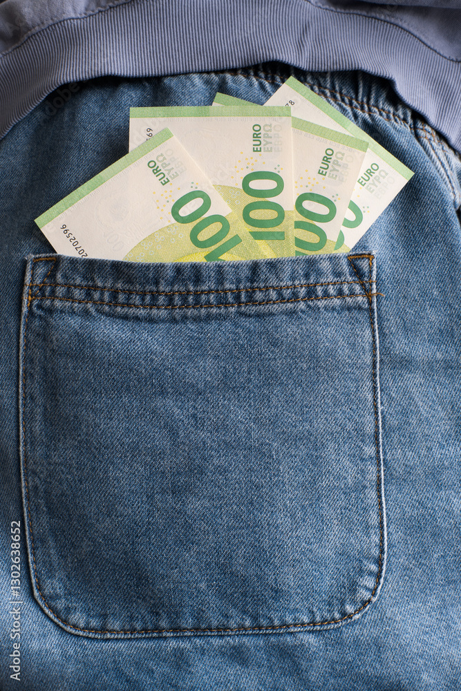 Euro banknotes in trouser pocket.