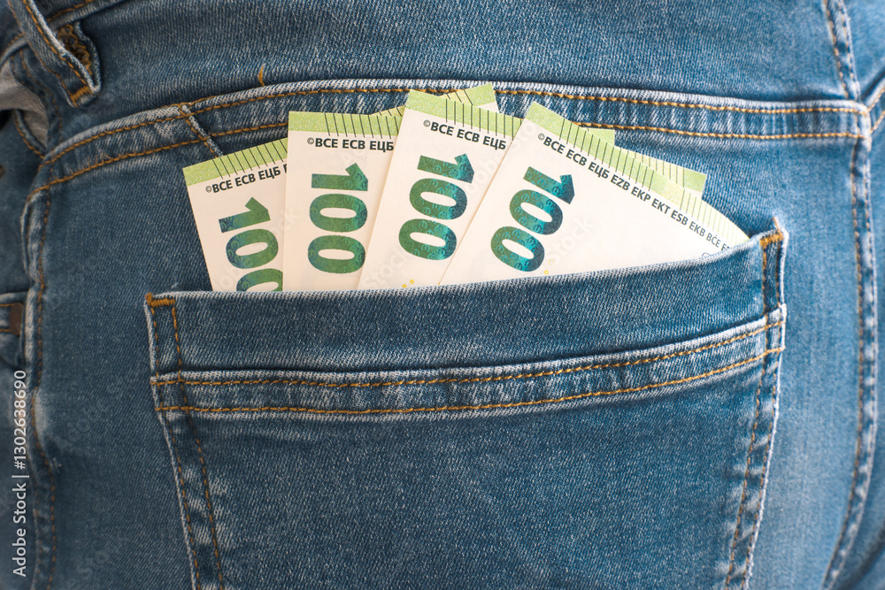 Euro banknotes in trouser pocket.