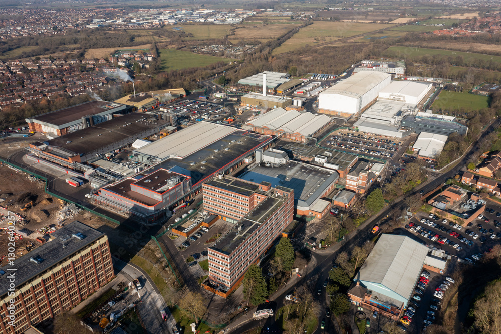 Aerial drone photo of the city of York in North Yorkshire, England showing the large Nestle chocolate factory in the city showing the large building surrounded by houses and homes in the winter time