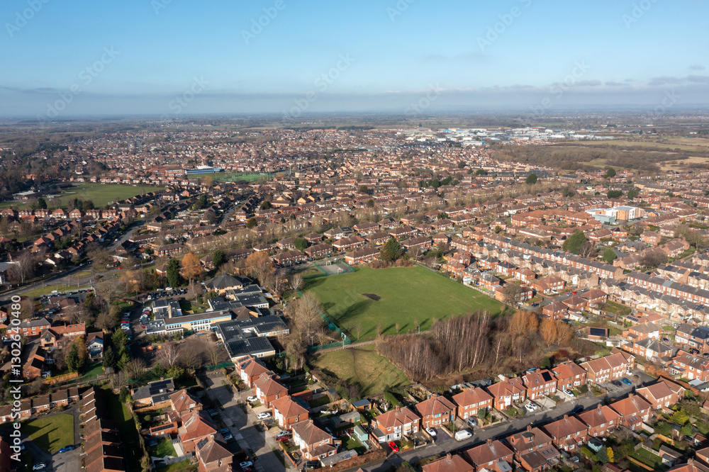 Aerial drone photo of the city of York in North Yorkshire England showing a birds eye view of the British town and rows of houses and large suburban housing estates taken in the winter time
