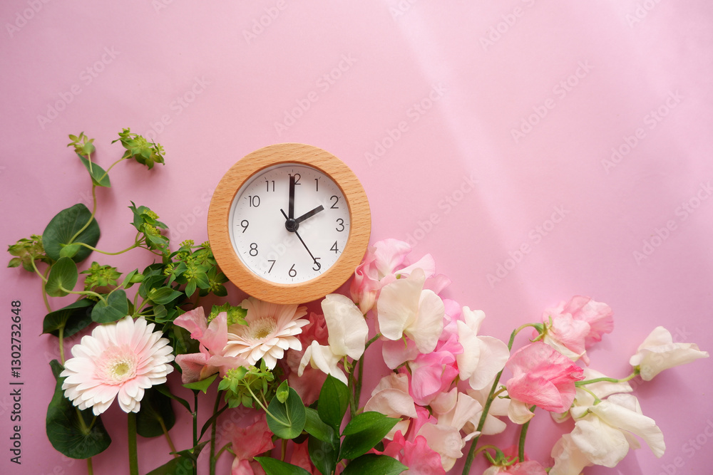 Spring forward background. Beautiful flowers and a clock composition on pastel color background. Spring image and floral background.