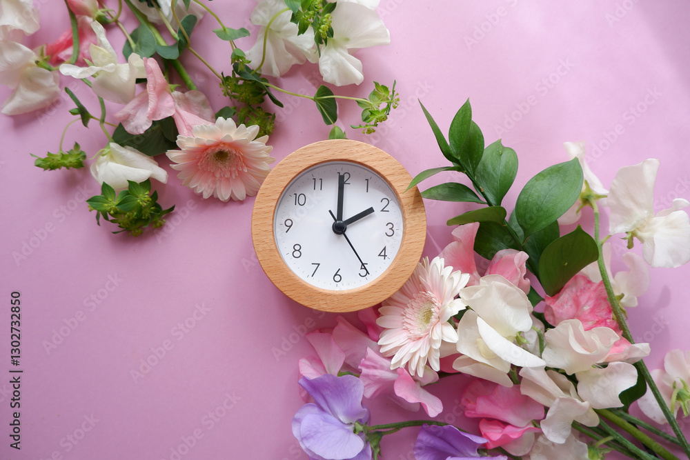 Spring forward background. Beautiful flowers and a clock composition on pastel color background. Spring image and floral background.