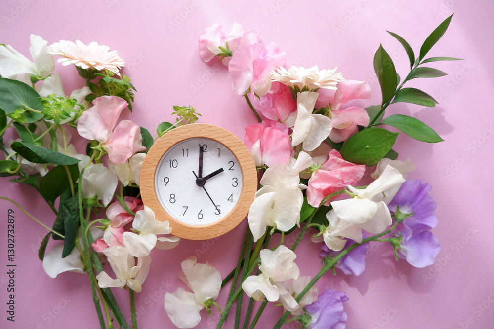 Spring forward background. Beautiful flowers and a clock composition on pastel color background. Spring image and floral background.