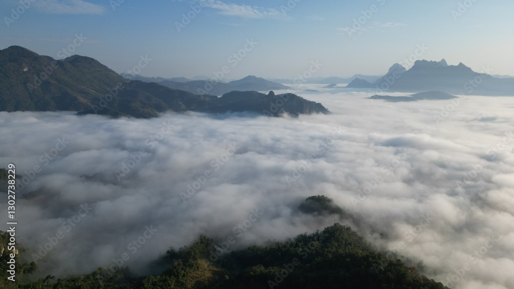 view of towering mountains enveloped in a sea of mist, with the soft glow of the morning sun casting a warm and peaceful light across the landscape. The mist creates an ethereal atmosphere, enhancing view of towering mountains enveloped in a sea of mist, with the soft glow of the morning sun casting a warm and peaceful light across the landscape. The mist creates an ethereal atmosphere, enhancing