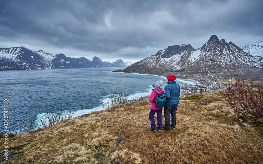 Fototapeta premium active woman hiking in fall in the mountain an sea landscape of the Meford above Mefjordvaer on Senja Island in northern Norway