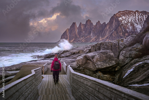 woman hiking in dramatic wi...