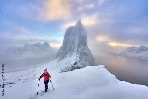 Woman  hiking in winter up ...