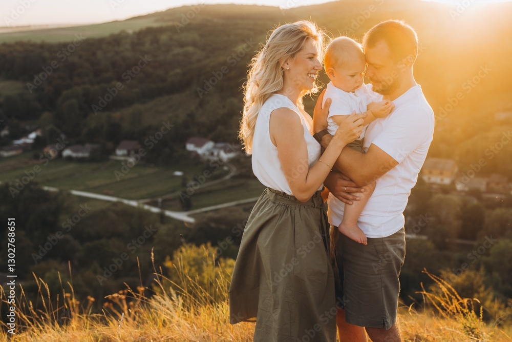 Happy Family Enjoying a Beautiful Sunset on a Scenic Hilltop Overlooking a Serene Village Landscape Happy Family Enjoying a Beautiful Sunset on a Scenic Hilltop Overlooking a Serene Village Landscape