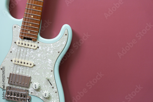 Electric guitar on red table background, close up music concept photo