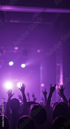 Crowd enjoys vibrant music performance under purple lights at local venue during nighttime concert event. Vertical HD background.