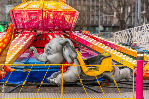 Photography Gray elephant on a children's csrousel at a fair