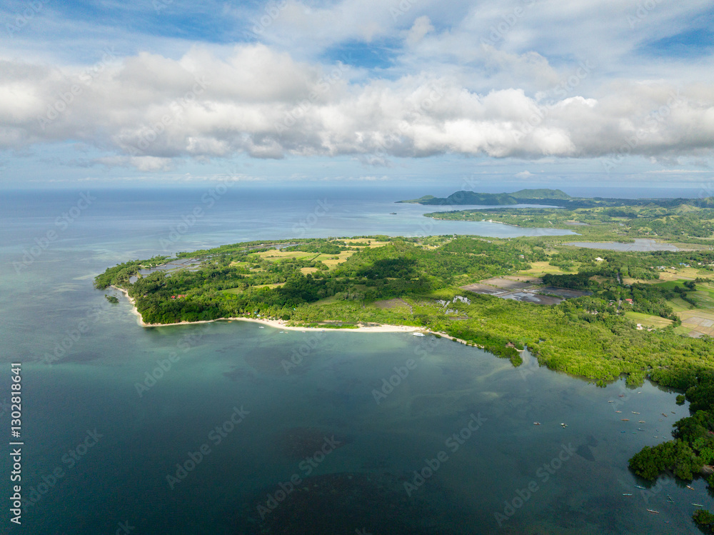 Island with beach and turquoise sea water. Blue sky and clouds. Looc, Tablas Island. Romblon, Philippines. Island with beach and turquoise sea water. Blue sky and clouds. Looc, Tablas Island. Romblon, Philippines.