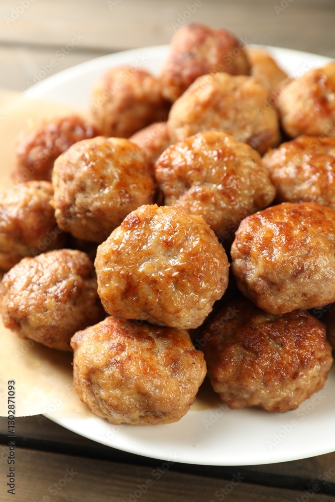 Many delicious meatballs on wooden table, closeup Many delicious meatballs on wooden table, closeup