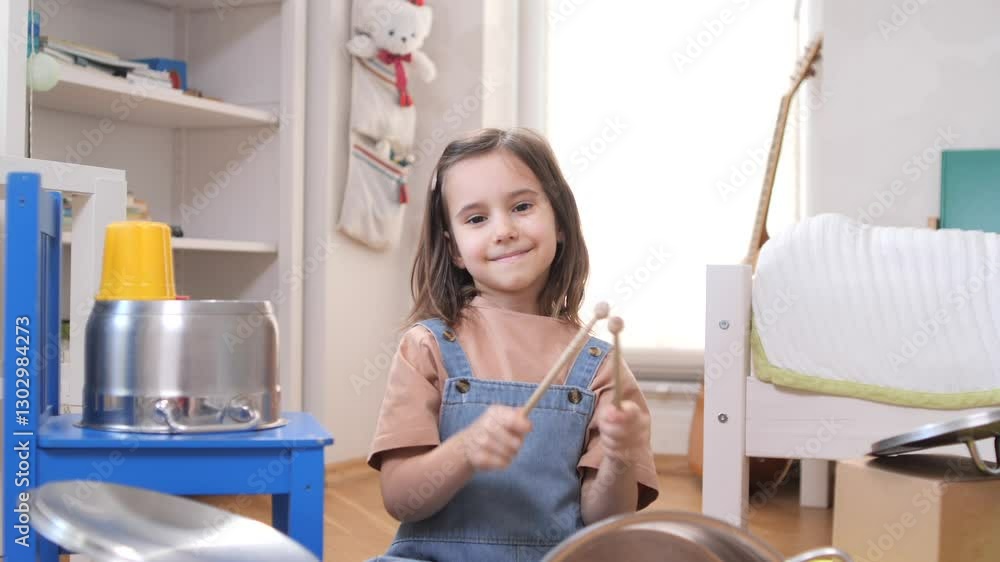 portrait Smiling little girl playing with toy kitchen utensils and pots portrait Smiling little girl playing with toy kitchen utensils and pots