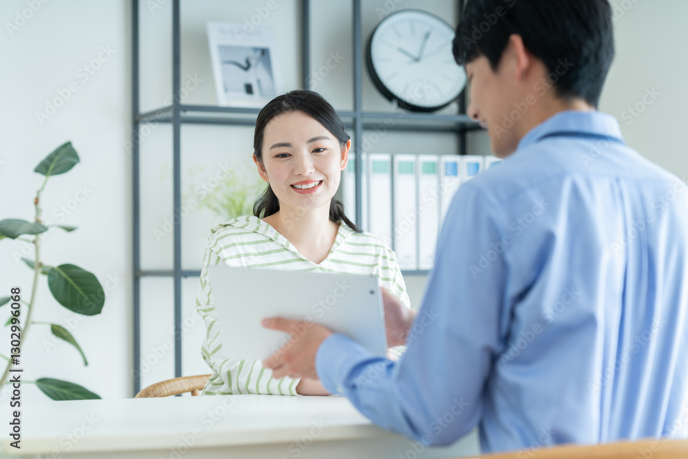 Obraz premium プランナーに相談する若い女性