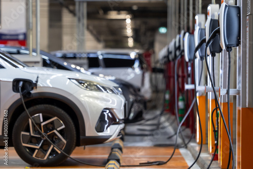 EV charging station electric car, Electric car charging station for charge EV battery, Plug for vehicle with electric engine, EV charger clean energy, Charging point at car parking lot.