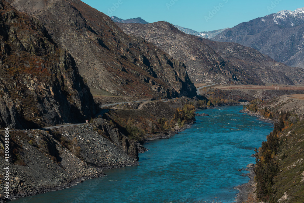 A cold river flowing through the rocky mountains of the Altai Republic, surrounded by rugged natural beauty.