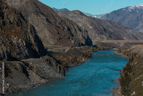 Obraz na płótnie A cold river flowing through the rocky mountains of the Altai Republic, surrounded by rugged natural beauty. w salonie