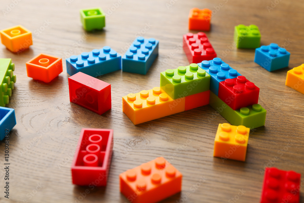 Construction toy. Colorful building bricks on wooden table, closeup Construction toy. Colorful building bricks on wooden table, closeup