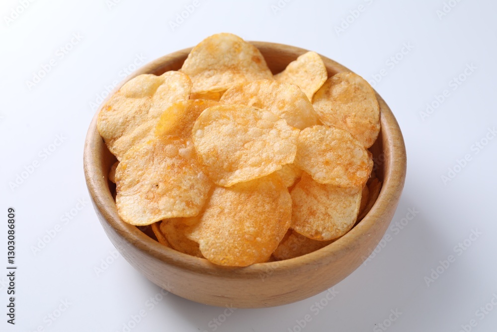 Tasty potato chips in bowl on white background, closeup Tasty potato chips in bowl on white background, closeup
