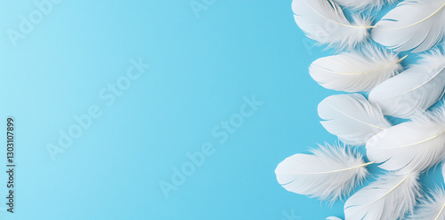 Soft white feathers on serene blue background create calming and elegant atmosphere. This abstract design is perfect for various creative projects
