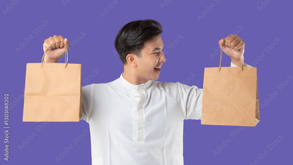 A man holds a brown paper bag and smiles. Ramadan and Eid celebrations on purple background A man holds a brown paper bag and smiles. Ramadan and Eid celebrations on purple background