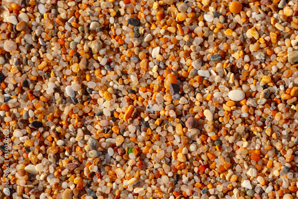 Beautiful texture of coarse beach sand. Beach-themed background image. Wet beach sand of large fraction Beautiful texture of coarse beach sand. Beach-themed background image. Wet beach sand of large fraction