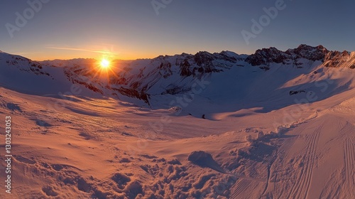 Sunset over snowy mountain range.