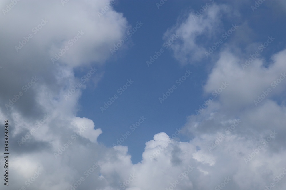 Expansive Blue Sky Framed by Gentle, Billowing Cumulus Clouds on a Summer Day Expansive Blue Sky Framed by Gentle, Billowing Cumulus Clouds on a Summer Day