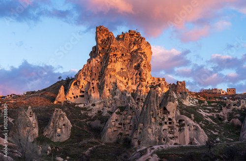 Scenic view of Uchisar Castle at sunset, Central Anatolia, Turkey. Ancient cave dwellings carved in rock