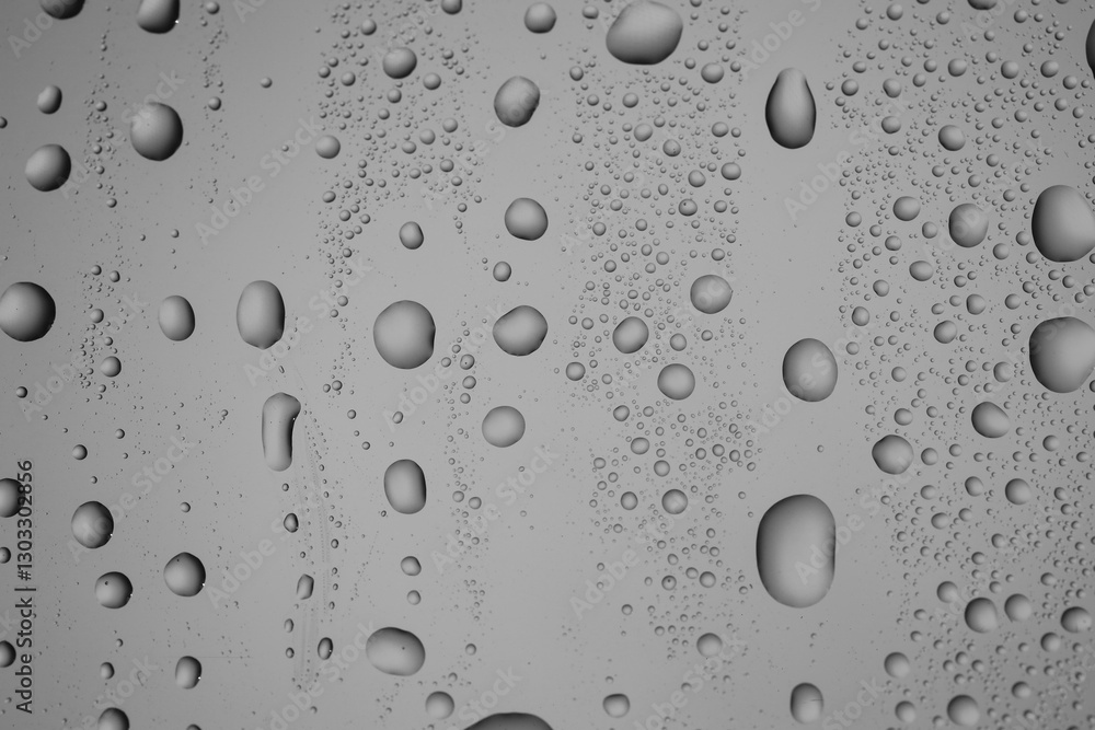 Water drops on grey glass surface, top view Water drops on grey glass surface, top view