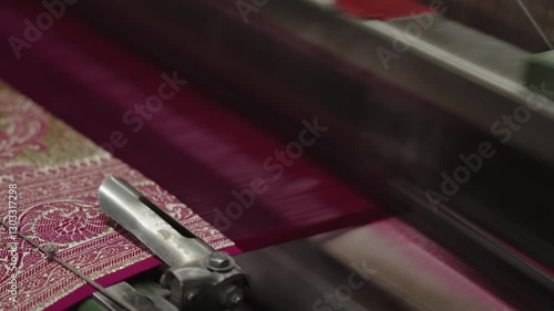 A mechanical machine makes silk fabric in an Indian factory. Fabric Yarn. Weaving style