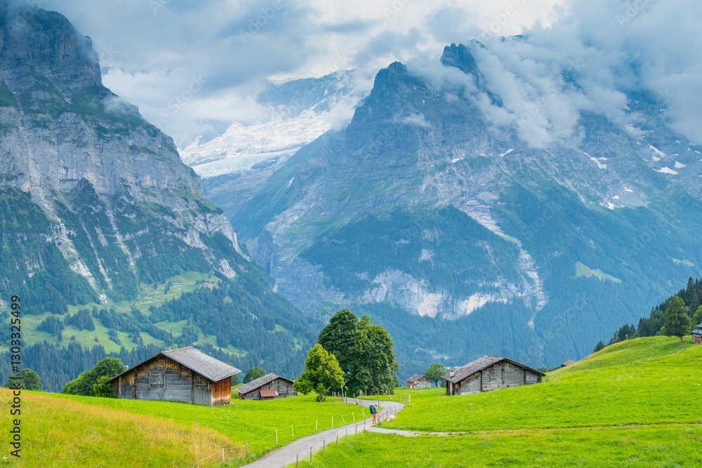 View on the alpine valley Grindelwald. Jungfrau, Switzerland. Under the Bernese alps. Mountain village. View on the alpine valley Grindelwald. Jungfrau, Switzerland. Under the Bernese alps. Mountain village.