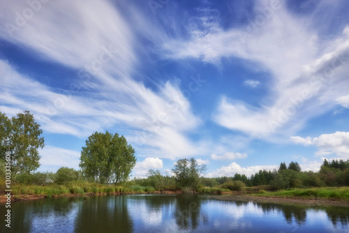The landscape features a cloudy sky above a picturesque river.