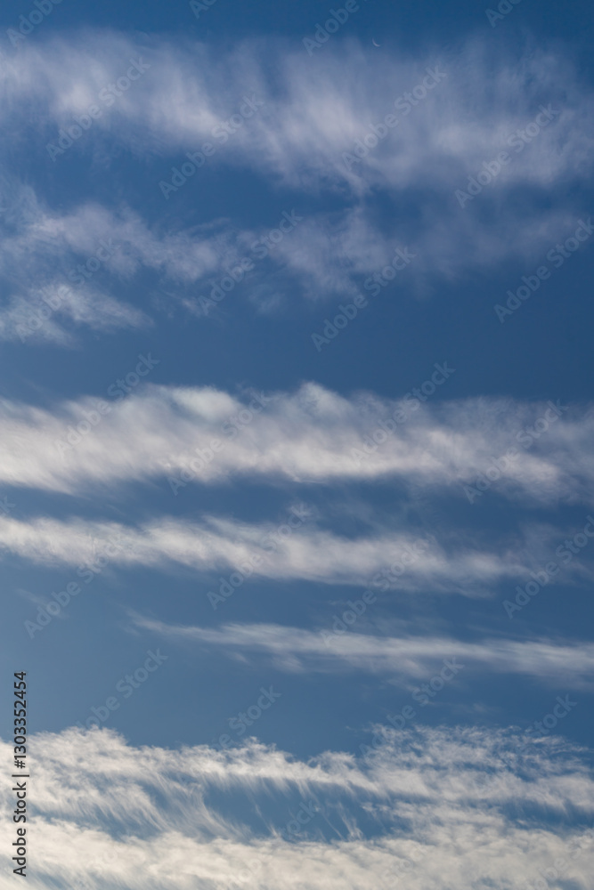 Cirrus Clouds Under a Clear Sky Creating a Calm and Serene Atmosphere
