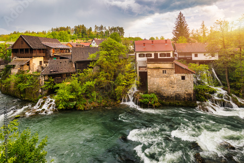 Village of Rastoke near Slunj in Croatia, old water mills on waterfalls of Korana river, beautiful countryside landscape. Landscape with river and little waterfalls in Rastoke village, Croatia. photo