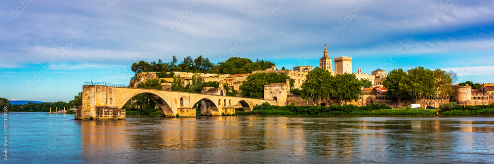 Fototapeta premium Beautiful view of Avignon with famous bridge Saint-Benezet, medieval architecture along the Rhone River in Avignon, France. The Pont Saint Benezet and the Papal palace in Avignon, South France.