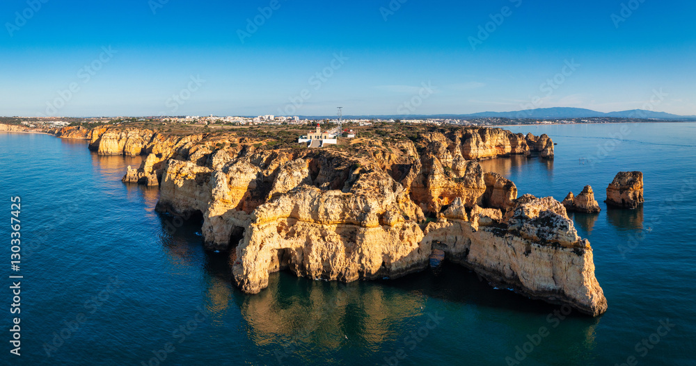 Panoramic view, Ponta da Piedade near Lagos in Algarve, Portugal. Cliff rocks and tourist boat on sea at Ponta da Piedade, Algarve region, Portugal. Ponta da Piedade, Algarve region, Portugal.