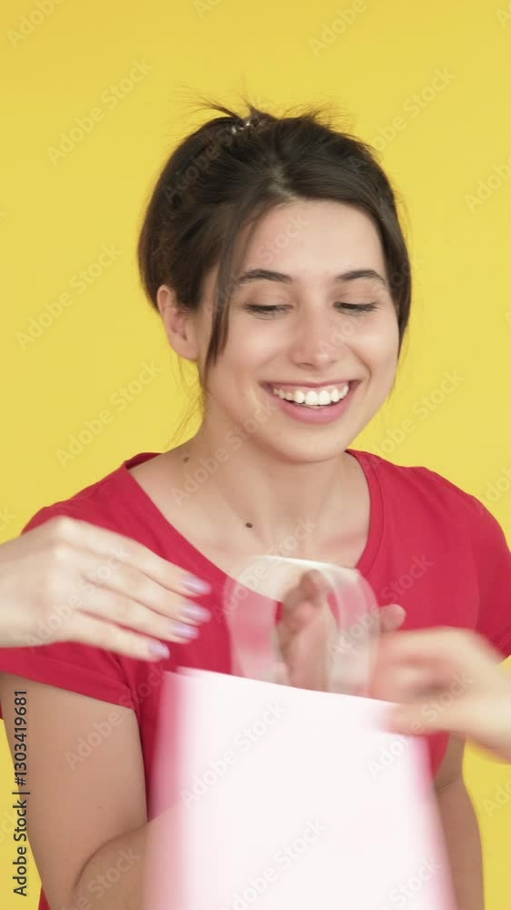 Vertical video. Shopping failure. Disappointed woman missing purchase bags isolated on yellow free space background. Vertical video. Shopping failure. Disappointed woman missing purchase bags isolated on yellow free space background.