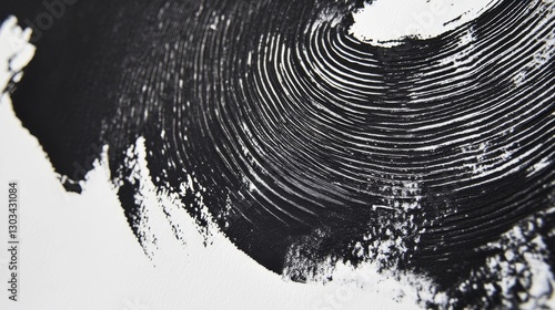 Close-up of black ink from a linocut print, showing the roller's texture on white paper.
