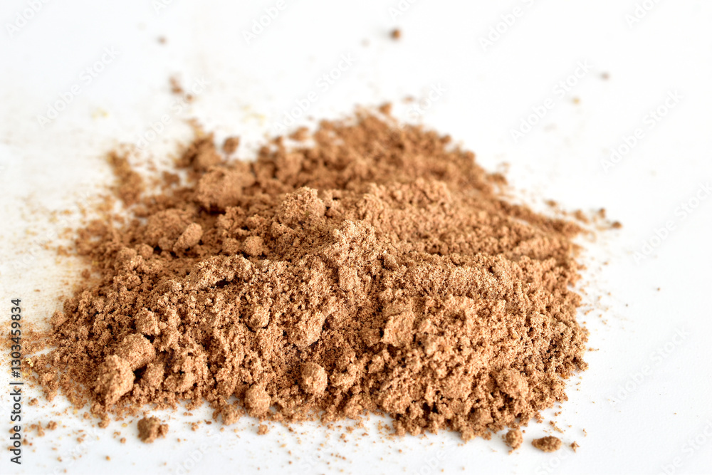 Dry, ground and aromatic spice cinnamon lies on a white background. Dry, ground and aromatic spice cinnamon lies on a white background.