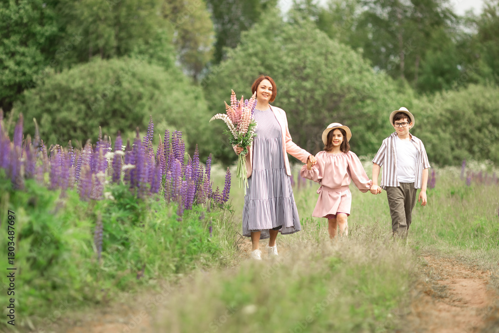 Happy caucasian family walking in lupine field with mother holding flowers Happy caucasian family walking in lupine field with mother holding flowers