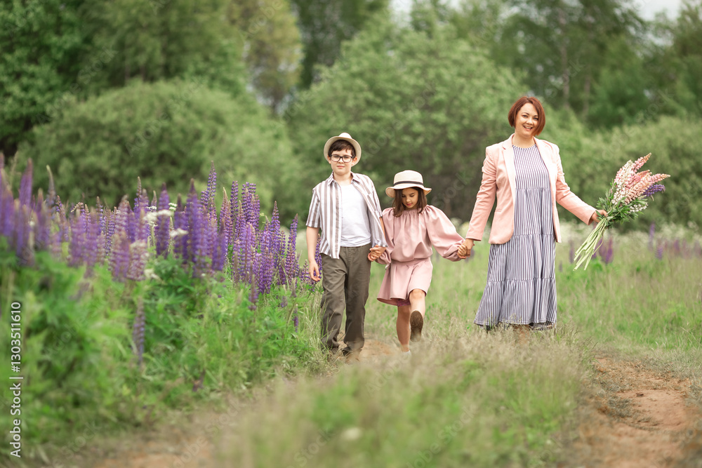 Fototapeta premium Mother with children walking in meadow holding flowers