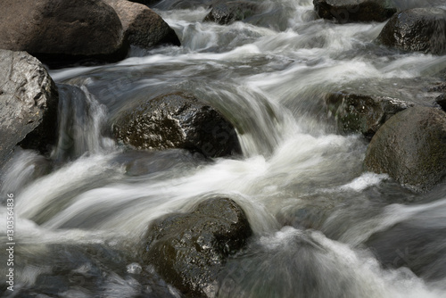 Fotografi Long exposure stream with boulders.
