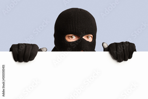 Φωτογραφία Closeup portrait of disguised looter peeping out white blank advert billboard, i
