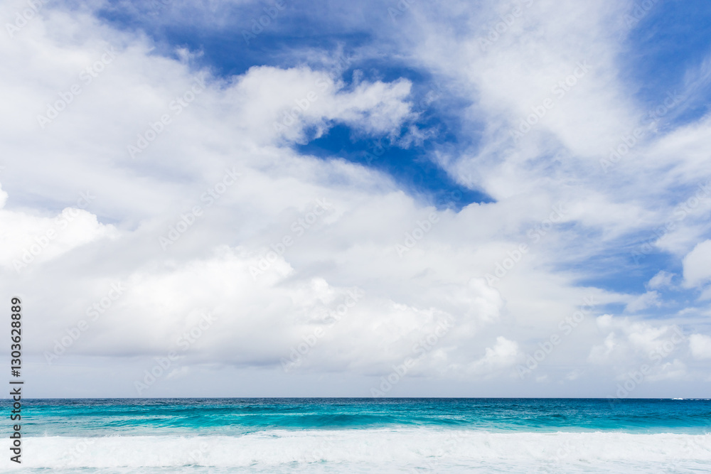 Peaceful ocean waters meet a vibrant blue sky. Mahe, Seychelles Peaceful ocean waters meet a vibrant blue sky. Mahe, Seychelles